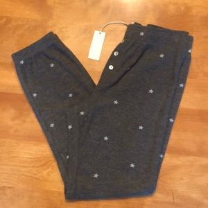 NWT. Gray joggers with stars all over front and back.